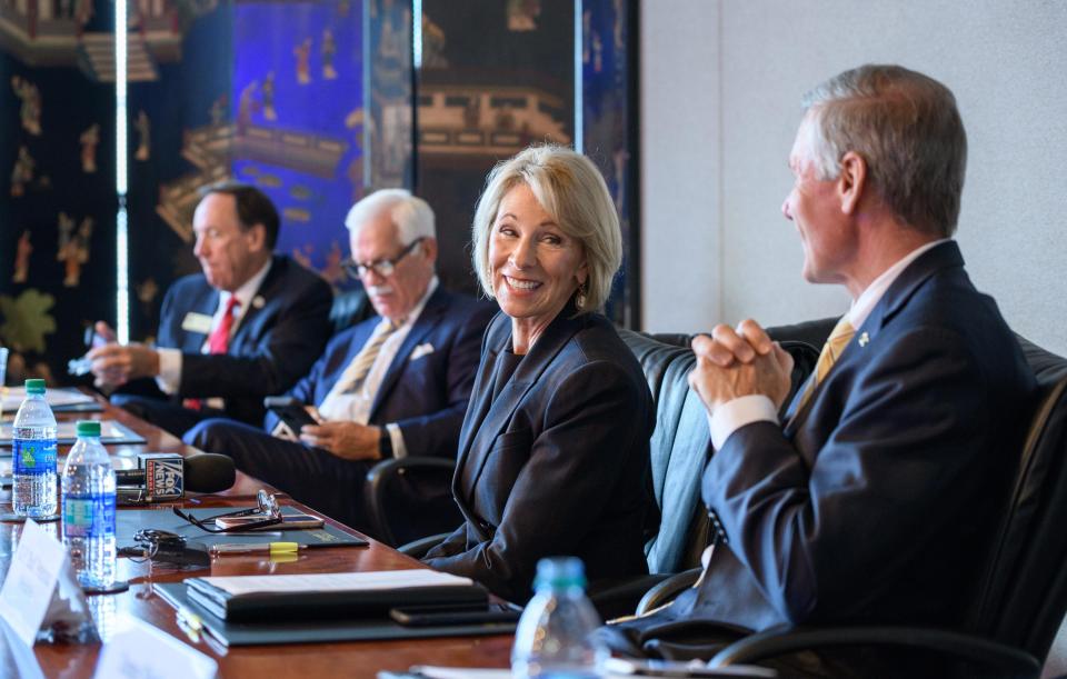 Betsy DeVos sitting at conference table with members of Georgia Tech leadership