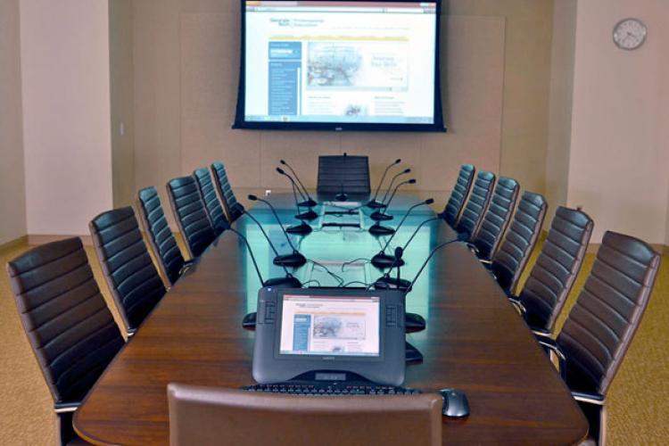 Empty conference room with presentation displayed on project screen
