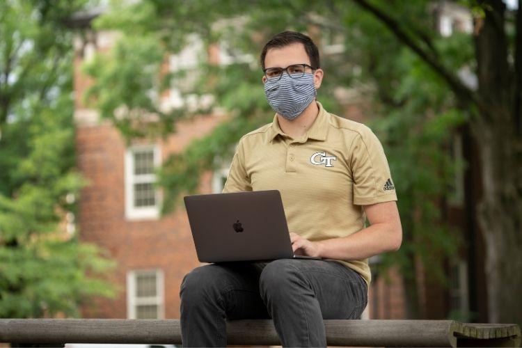 Online graduate learner wearing mask
