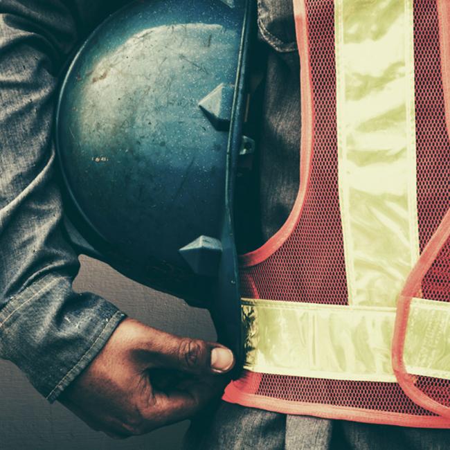Construction worker holding a helmet